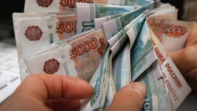Russian ruble drops to record lows amid fresh sanctions