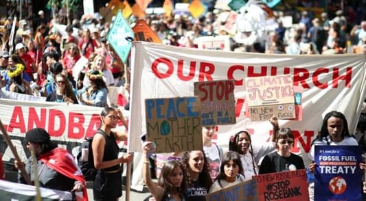 Climate protesters throng New York, demand end to fossil fuels