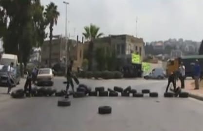 Supporters of Bilal Bin Rabah mosque’s Cleric Sheikh Ahmad Al Assir converge outside a Saida cemetery to prevent the burial of a Hezbollah member who was killed in Syria