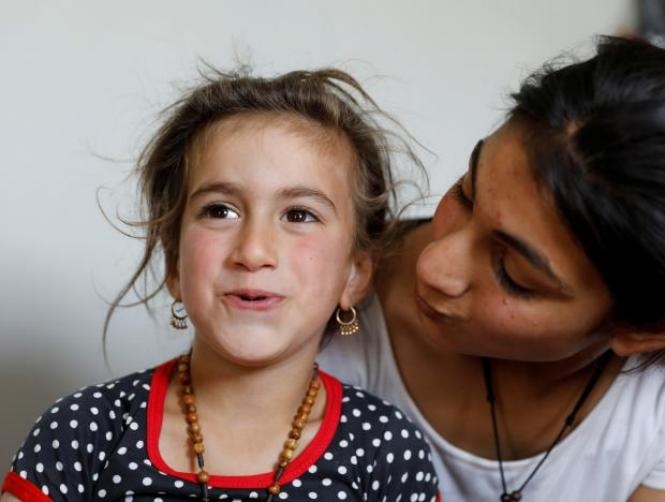 Iraqi Christian girl freed from Islamic State says 'mum, dad' again