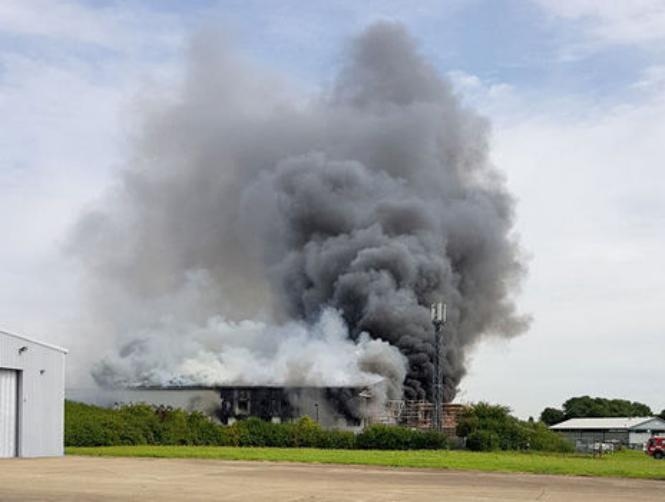 Photos: Explosion near Southend Airport, UK, black smoke rising from air hanger - RT