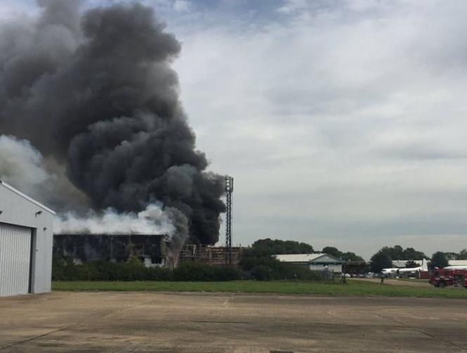 Photos: Explosion near Southend Airport, UK, black smoke rising from air hanger - RT