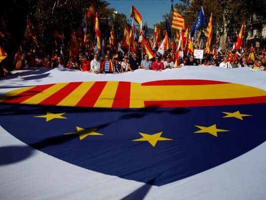 Hundreds of thousands march for unified Spain, poll shows depths of division