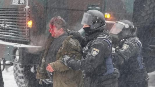 Ten injured in clashes as police break up protest camp in Ukraine