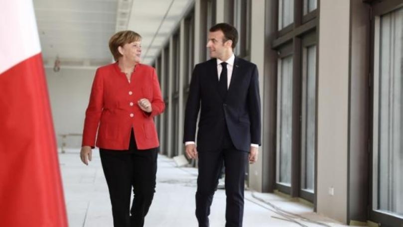 Amid trade tensions, Merkel commends Macron's 'elan'