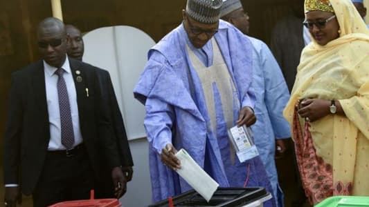 Nigeria's Buhari casts ballot as polls open in delayed election