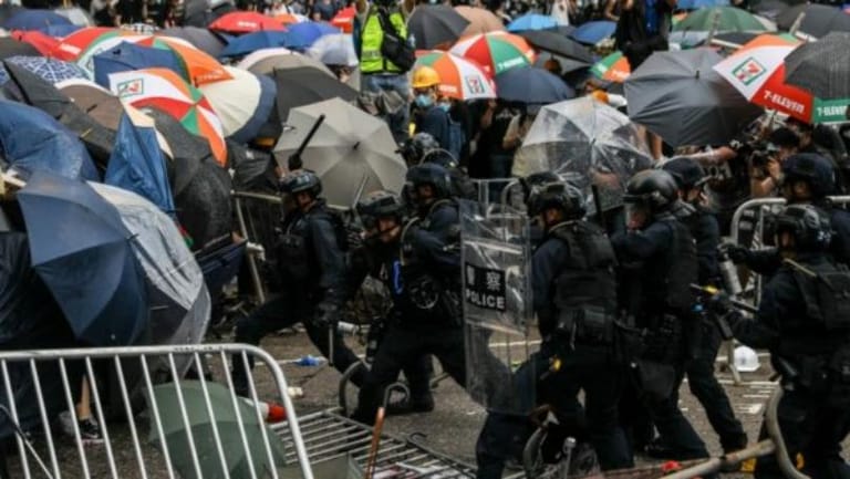 After scuffles, Hong Kong police warn protesters to refrain from violence, leave scene