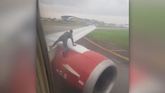 Man Climbs Onto Wing of Plane As It Prepares for Take Off