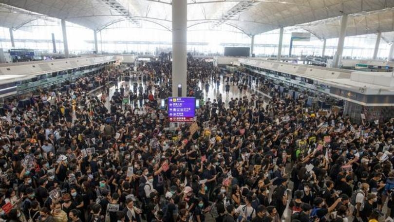 Hong Kong airport grinds to a halt as protests swell