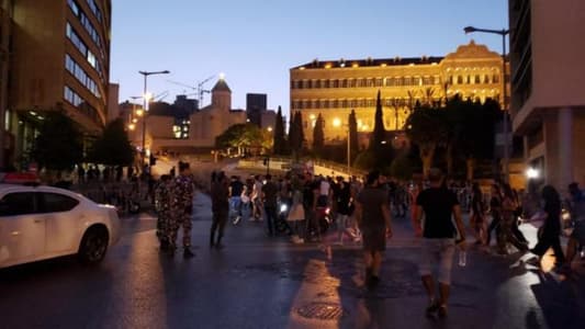 Political procession intercepts protesters in downtown Beirut and gunfire heard in the area