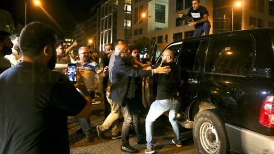 Photo: Minister Akram Chehayeb tries to prevent one of his companions from shooting at demonstrators in downtown Beirut