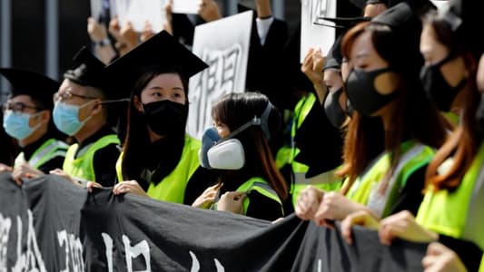 Masked university students rally at graduation ceremony in Hong Kong