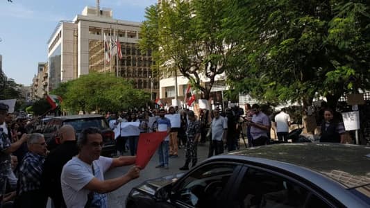 Protesters gather outside the Central Bank