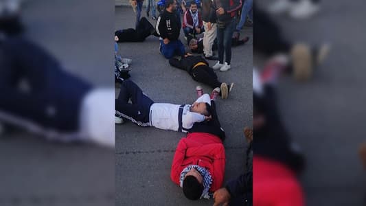 Photo: Protesters block the road with their bodies in front of Al-Salam Hospital in Tripoli