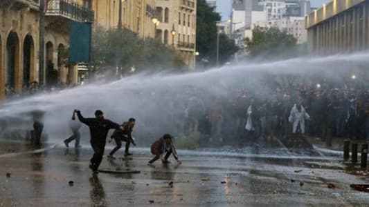 Security forces are using water cannons to disperse the demonstrators in Riad El-Solh Square after they removed one of the iron gates