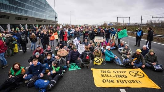 Climate activists block Amsterdam highway in protest against ING