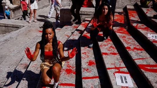 Women's rights activists cover Rome's Spanish Steps in red paint