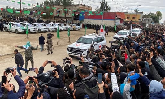 Red Cross vehicles left after retrieving the three hostages from Hamas in Deir al-Balah