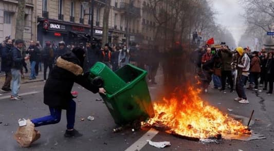 Embattled Macron heads to China, leaving burning Paris behind