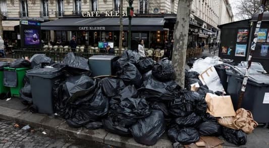 Garbage piles up in Paris as Macron vows to push through pension reform