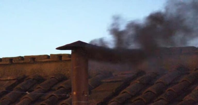 Black smoke rises from the Vatican, signaling that no new pope has been elected
