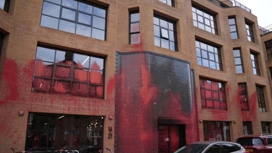 Watch: British activists paint a party's headquarters in red