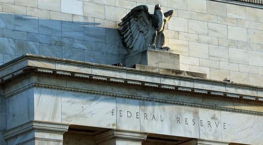 Fed hikes rates by a quarter percentage point, indicates increases are near an end