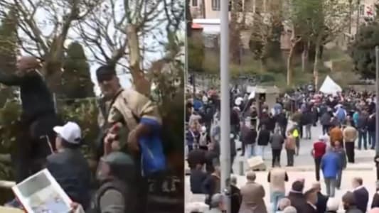 A number of Protesters are trying to cross the iron barriers