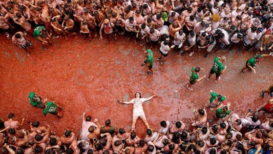 Spanish town gets soaked in red during tomato-lobbing Tomatina festival