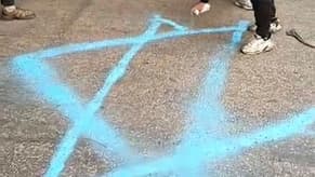 Watch: Hezbollah Supporters Draw Israeli Symbols on Airport Road