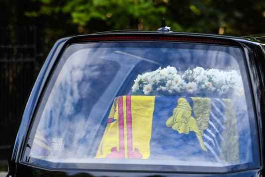 The coffin carrying the body of Queen Elizabeth II left her beloved Balmoral Castle today, beginning a six-hour journey to the Scottish capital of Edinburgh