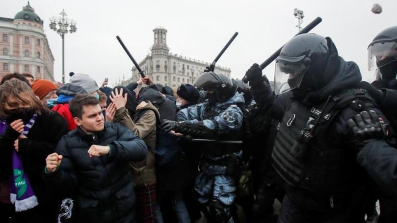Woman kicked by Russian policeman becomes protest symbol, seeks justice
